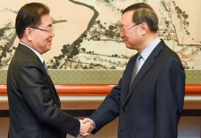 Chinese State Councilor Yang Jiechi, right, meets with South Korea's National Security Adviser Chung Eui-yong at the Diaoyutai state guesthouse in Beijing, China, March 12. (Reuters)