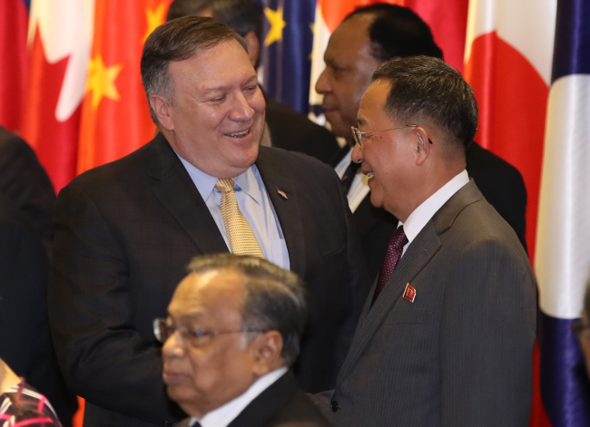 US Secretary of State Mike Pompeo shakes hands with NK Foreign Minister Ri Yong-ho at the annual ASEAN Regional Forum in Singapore on Saturday. (Yonhap)