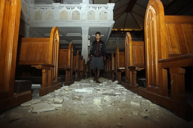 A man walks inside a cathedral where debris has fallen after an earthquake in Bali, Indonesia, Sunday, Aug. 5.  (AP)