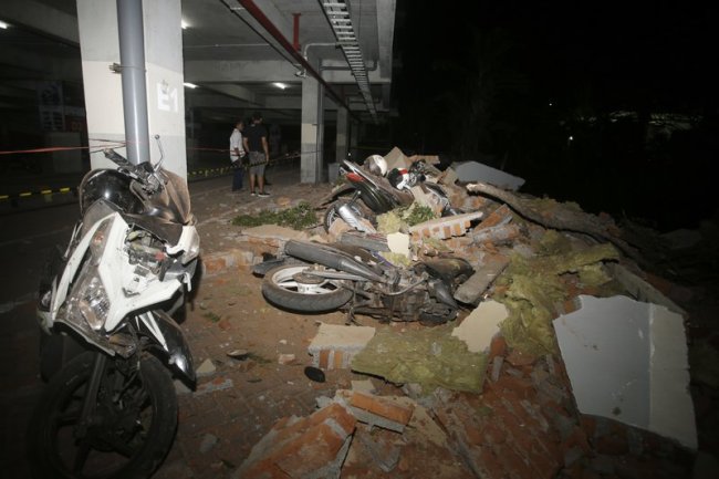 Debris on top of a motorcycles after an earthquake in Bali, Indonesia, Sunday, Aug. 5. (AP)