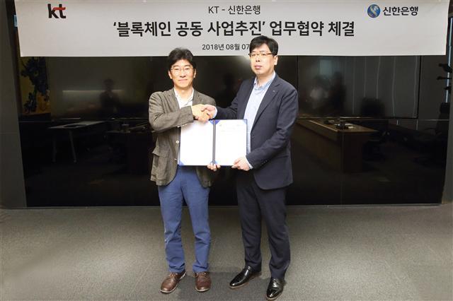 KT 플랫폼서비스기획담당 김학준 상무(왼쪽)와 신한은행 디지털전략본부 장현기 본부장이 업무 협약을 맺고 있다. [제공=KT]