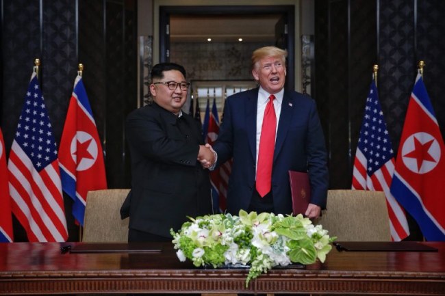 North Korea's leader Kim Jong-un shakes hands with US President Donald Trump during Singapore summit in June. Yonhap