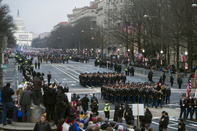 Military units participate in the inaugural parade from the Capitol to the White House in Washington, Friday, Jan. 20, 2017. A US official says the 2018 Veterans Day military parade ordered up by President Donald Trump would cost about $92 million _ more than three times the maximum initial estimate. (AP)