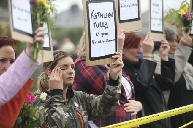 People hold up names of children as they gather to protest at the site of the former Tuam home for unmarried mothers in County Galway, during the visit to Ireland by Pope Francis, Sunday, Aug. 26. (AP)