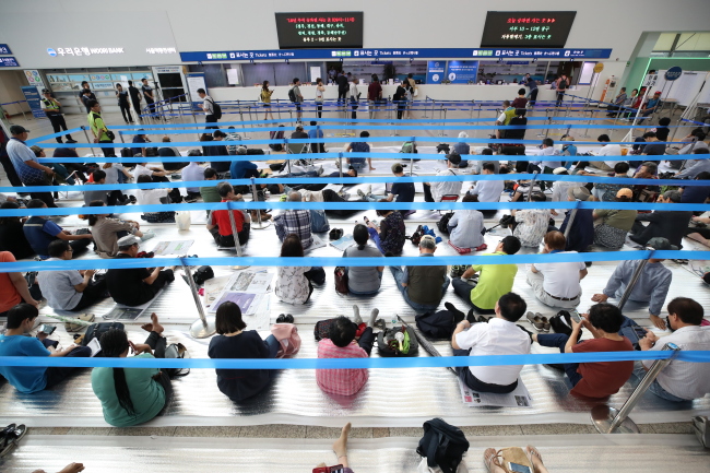 People line up to purchase train tickets at Seoul Station in Yongsan-gu, Seoul, on Tuesday. Ticket sales at designated physical locations opened at 9 a.m. (Yonhap)