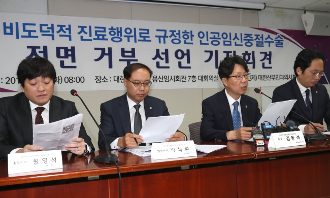 Kim Dong-suk (second from right), the head of the Korean College of Ob & Gyn, attends a press conference along with his colleagues in Seoul, Tuesday. (Yonhap)