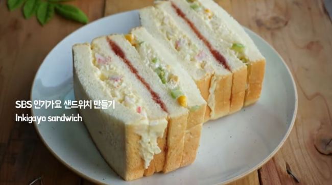 The original Inkigayo sandwich made with egg potato salad, cabbage salad, and strawberry jam between slices of white bread