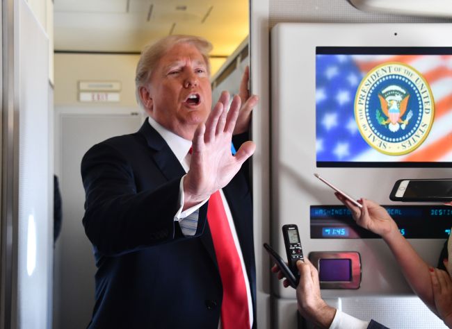 US President Donald Trump talks with reporters on Air Force One (Yonhap)