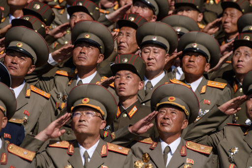 Korean People's Army (KPA) soldiers salute as they watch a mass rally on Kim Il Sung square in Pyongyang on September 9, 2018. (AFP)