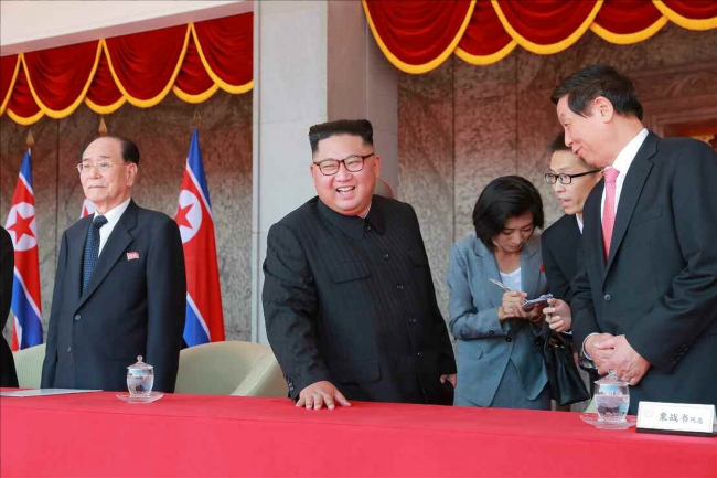 North Korean leader Kim Jong-un watches a military parade on Sunday held in celebration of the 70th anniversary of the regime's founding. (Yonhap)
