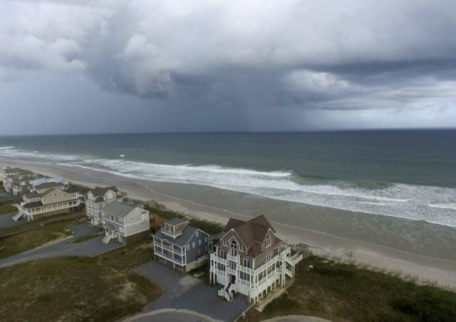 A storm front passes homes in North Topsail Beach, N.C., prior to Hurricane Florence moving toward the east coast on Wednesday, Sept. 12, 2018. (AP)