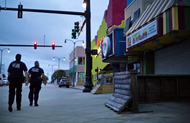 Police patrol the boardwalk in Myrtle Beach, S.C., as Hurricane Florence approaches the east coast. (AP)