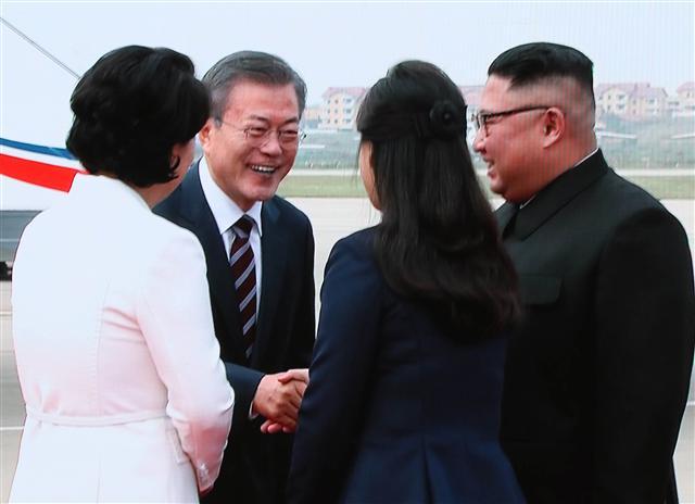 ‘2018남북정상회담평양’의 첫날인 18일 평양 순안공항에 도착한 문재인 대통령 부부가 마중 나온 김정은 북한 국무위원장 부부와 인사를 나누고 있는 장면이 이날 서울 중구 DDP 메인프레스센터에 중계되고 있다.  [연합뉴스]