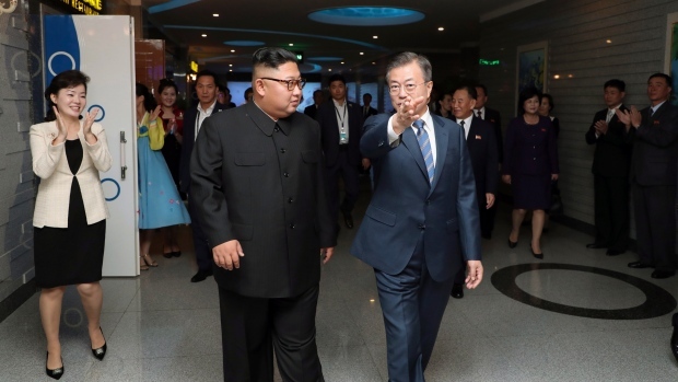 South Korean President Moon Jae-in, right, and North Korean leader Kim Jong Un walk for a dinner at Taedong river seafood restaurant in Pyongyang, North Korea, Wednesday, Sept. 19. (Pyeongyang Press Corps-AP)