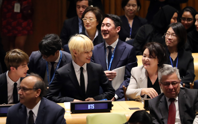 BTS leader RM speaking at the United Nations General Assembly during the Generation Unlimited launch event with UN officials looking on, September 24, 2018