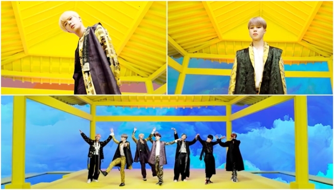 BTS members wearing modernized black and gold hanbok designed by Baek Oak-soo in the Idol music video, with the traditional goreum ribbon removed