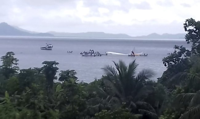 This image made from video photo provided by John Karl Louie Mallari shows an Air Niugini plane floating in Pacific lagoon near Chuuk Airport in Weno, Federated States of Micronesia, Friday, Sept. 28. (AP)