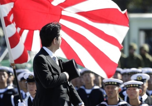 Japanese Prime Minister Shinzo Abe pays respect to Rising Sun Flag during a military ceremony. Yonhap
