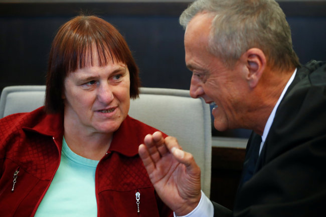 Defendant Angelika Wagener talks to her lawyer Peter Wueller before her verdict at a local court in Paderborn, Germany, October 5, 2018, in the so-called "House of Horror" murder trial in the western German city of Hoexter. (Reuteres)