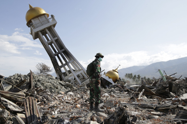 <YONHAP PHOTO-4725> An Indonesian trooper stands beside a toppled mosque as recovery efforts continue at the earthquake-hit Balaroa neighborhood in Palu, Central Sulawesi, Indonesia on Saturday Oct. 6, 2018. Search teams pulled bodies from obliterated neighborhoods in the disaster-stricken Indonesian city of Palu on Saturday as more aid rolled in and the government said it was considering making devastated areas into mass graves. (AP Photo/Aaron Favila)/2018-10-06 22:27:43/ <저작권자 ⓒ 1980-2018 ㈜연합뉴스. 무단 전재 재배포 금지.>
<YONHAP PHOTO-4725> An Indonesian trooper stands beside a toppled mosque as recovery efforts continue at the earthquake-hit Balaroa neighborhood in Palu, Central Sulawesi, Indonesia on Saturday Oct. 6, 2018. Search teams pulled bodies from obliterated neighborhoods in the disaster-stricken Indonesian city of Palu on Saturday as more aid rolled in and the government said it was considering making devastated areas into mass graves. (AP Photo/Aaron Favila)/2018-10-06 22:27:43/ <저작권자 ⓒ 1980-2018 ㈜연합뉴스. 무단 전재 재배포 금지.>