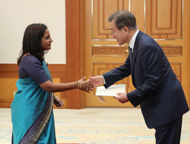 Sripriya Ranganathan, Indian ambassador to South Korea, shakes hands with South Korean President Moon Jae-in at Cheong Wa Dae in Seoul on Monday. (Yonhap)