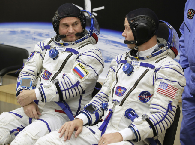 US astronaut Nick Hague, right and Russian cosmonaut Alexey Ovchinin, member of the main crew of the expedition to the International Space Station (ISS), speak prior to the launch of Soyuz MS-10 space ship at the Russian leased Baikonur cosmodrome, Kazakhstan, Thursday, Oct. 11, 2018.