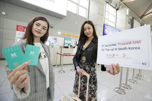 Models pose with KT Corp.'s top-up SIM card in this photo provided by the company on Oct. 12, 2018. (Yonhap)