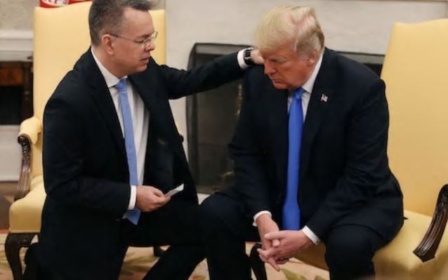 Andrew Brunson praying for President Donald Trump at the Oval Office (AP)