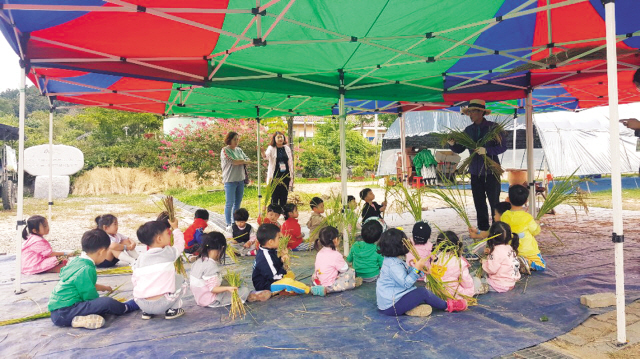 대청호 찬샘마을 가을농촌체험 교실 담당자(주민)가 이 곳을 찾은 어린이집 아이들에게 농기구 홀테에 대해 설명하고 있다. [제공=한국농어촌공사]