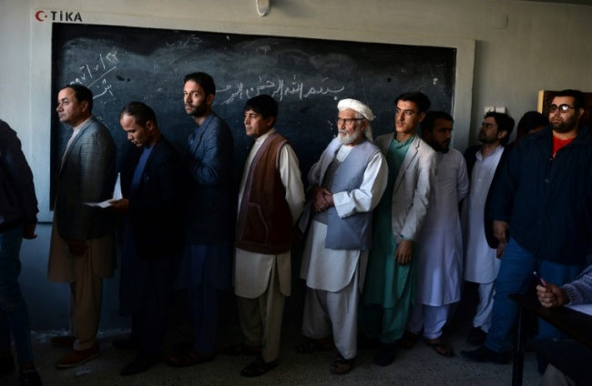 Around three million people defied the threat of militant attacks to cast their ballot in the long-delayed poll on Saturday, official figures showed, but many polling sites opened several hours late or not at all (AFP)