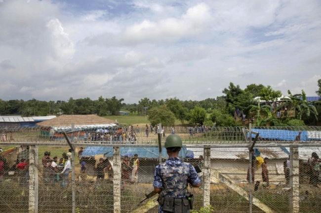 Myanmar police patrol a Rohingya camp on the border with Bangladesh on Aug. 24. (AFP)
