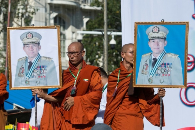 Monks in Yangon hold portraits of Myanmar's General Min Aung Hlaing, who the UN says should be investigated for genocide. (AFP)