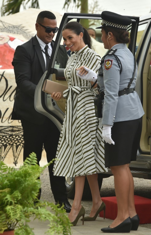 American-born Meghan wore a green-and-white striped cotton dress by Australian designer Martin Grant to tour the markets in Tonga's capital (AFP)