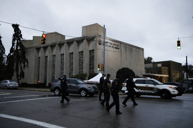 Police officers walk outside the Tree of Life Synagogue in the aftermath of a deadly shooting yesterday in Pittsburgh, early Sunday, Oct. 28, 2018 (AP)