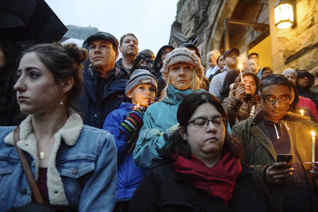 People stand on the stairs of Sixth Presbyterian Church as the crowd spills up the hill and down the street for a vigil blocks from where an active shooter shot multiple people at Tree of Life Congregation synagogue on Saturday, Oct. 27, 2018, in the Squirrel Hill section of Pittsburgh (AP)