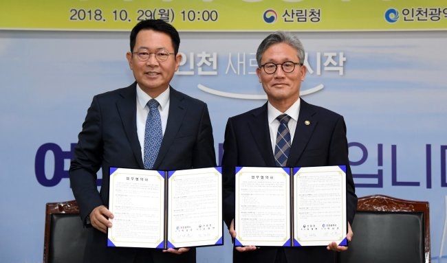 [사진설명=김재현 산림청장(오른쪽)과 박남춘 인천시장이 29일 인천광역시 남동구 인천광역시청에서 2019년 ‘아ㆍ태지역 산림위원회(APEC)’ 및 ‘제4차 아ㆍ태지역 산림주간(APFW)’ 등 산림분야 국제회의 공동 개최를 위한 업무협약을 체결하고 기념촬영 하고 있다. 사진=산림청 제공]