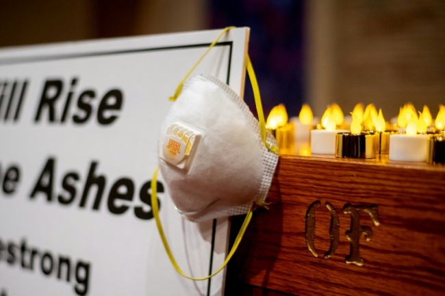 "We will rise from the ashes," said a sign on the altar at the church vigil for fire victims in Chico, California (AFP)