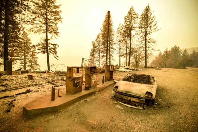 A burnt car at a gas station on November 11, 2018 after the "Camp" fire tore through the region near Pulga, east of Paradise, California (AFP)