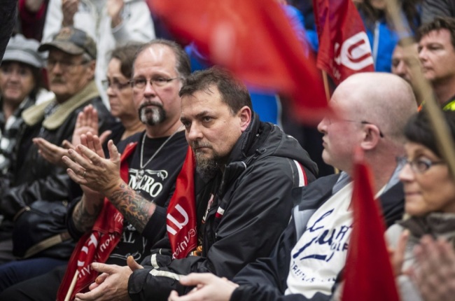Workers of Oshawa's General Motors car assembly plant, listen to Jerry Dias, president of UNIFOR, the union representing the workers, at the union headquarters in Oshawa, Ont. on Monday, Nov. 26, 2018. (AP)