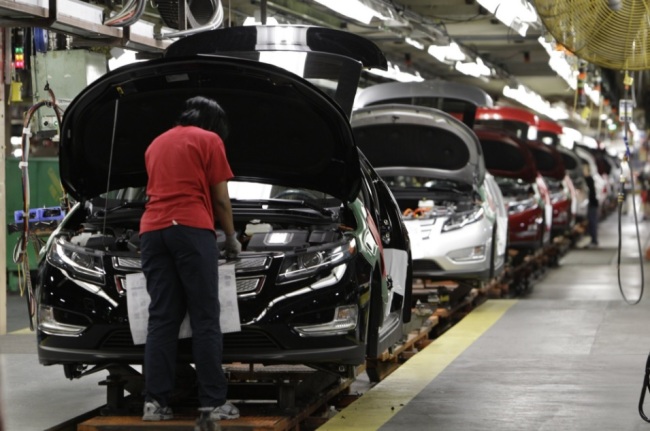 In this July 27, 2011, file photo, assembly worker Julaynne Trusel works on a Chevrolet Volt at the General Motors Hamtramck Assembly plant in Hamtramck, Mich. GM announced Monday, Nov. 26, 2018, that it will lay off thousands of factory and white-collar workers in North America and put five plants up for possible closure as it restructures to cut costs and focus more on autonomous and electric vehicles. Among the possibilities are the Detroit/Hamtramck assembly plant, which makes the Buick LaCrosse, the Chevrolet Impala and Volt, and the Cadillac CT6, all slow-selling cars. (AP)
