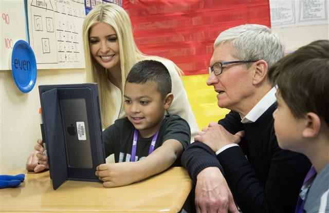 <YONHAP PHOTO-1232> Apple CEO Tim Cook, right, and Ivanka Trump, daughter and advisor to President Donald Trump, talk with first-grader Israel Perez about work he's doing on his iPad during a visit to Wilder Elementary School, in Boise Idaho, Tuesday, Nov. 27, 2018. Cooke and Trump visited the school to examine the district's use of technology. (Katherine Jones/Idaho Statesman via AP)/2018-11-28 06:12:24/ <저작권자 ⓒ 1980-2018 ㈜연합뉴스. 무단 전재 재배포 금지.>