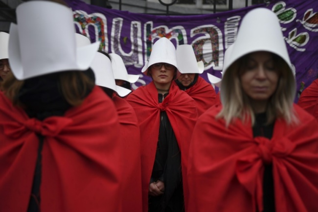 Activists in favor of the legalization of abortion don costumes inspired by Canadian author Margaret Atwood's feminist dystopian novel "The Handmaid's Tale;" a sequel is to be published next year (AFP)