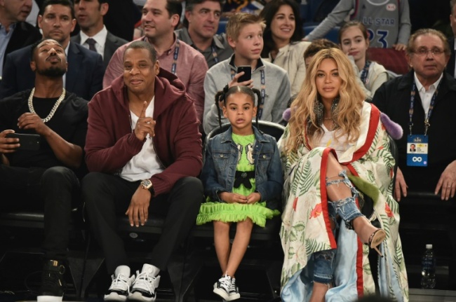 Beyoncé Knowles and Jay Z, pictured with their daughter in 2017, were a part of an all-star line-up at a concert in Johannesburg to honour the life and legacy of Nelson Mandela (AFP)