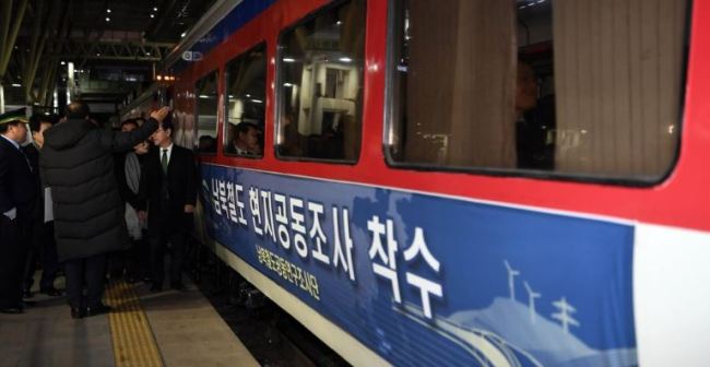 A sign on a train at Seoul Station in the capital on Nov. 30, 2018, says South and North Korea are launching a joint inspection of their railways. The train headed to North Korea's western city of Sinuiju on the day as the Koreas launched an 18-day inspection of rail lines to modernize and ultimately reconnect them across the border. (Yonhap)
