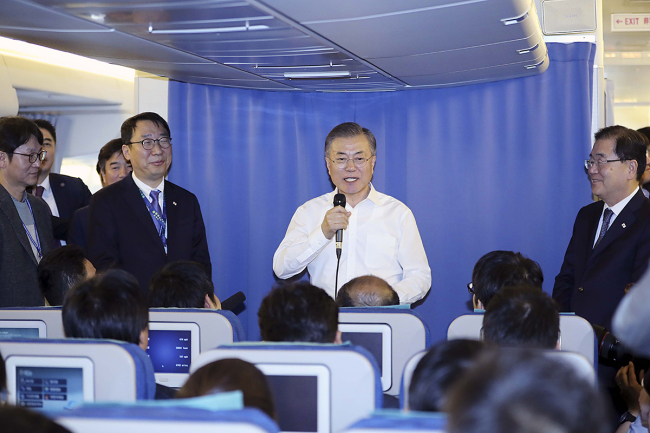 President Moon Jae-in speaks to the media aboard Air Force One on Saturday. Cheong Wa Dae