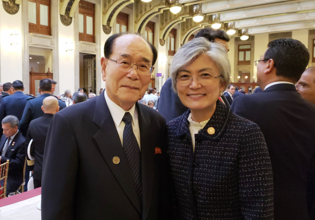 Kim Yong-nam, North Korea's nominal head of state, left, stands next to South Korean Foreign Minister Kang Kyung-wha in Mexico. (Yonhap)