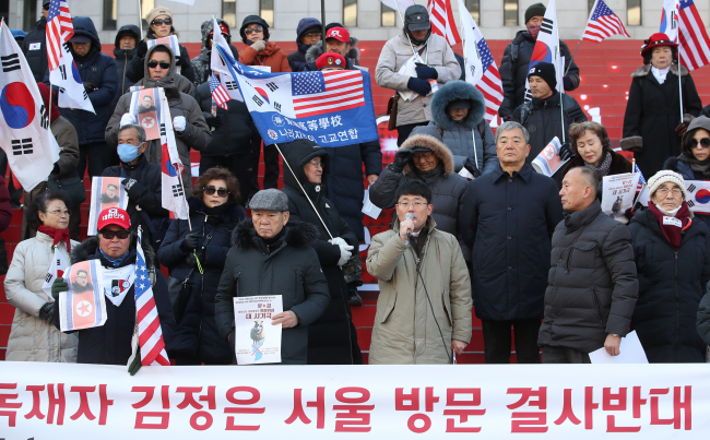 A conservative group stages a protest against Kim Jong-un's visit to Seoul. Yonhap