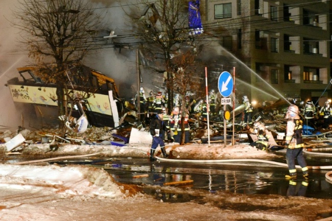 Firefighters work at the scene after an explosion at a restaurant in Sapporo, in the northern Hokkaido prefecture on December 16, 2018 (AFP)