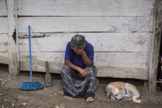 Elvira Choc, 59, Jakelin Amei Rosmery Caal's grandmother, rests her head on her hand in front of her house in Raxruha, Guatemala, on Saturday, Dec. 15, 2018. The 7-year old girl died in a Texas hospital, two days after being taken into custody by border patrol agents in a remote stretch of New Mexico desert. (AP)