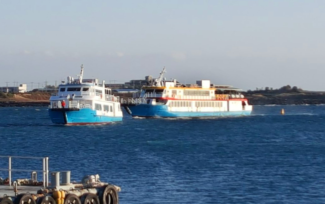 Ferry Blueray 1 is towed into port on Monday. Yonhap